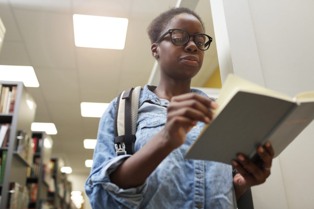 African student examining the book